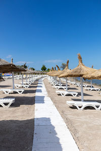 Scenic view of beach against clear blue sky