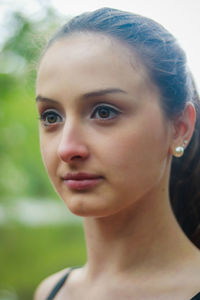 Close-up of beautiful young woman looking away
