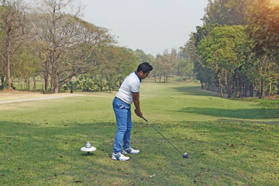 Full length of man standing on golf course