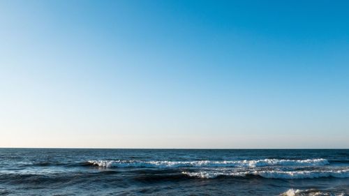 Scenic view of sea against clear blue sky