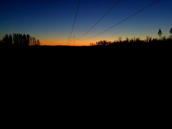 Silhouette landscape against clear sky during sunset