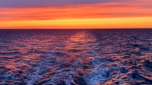 Scenic view of sea against romantic sky at sunset