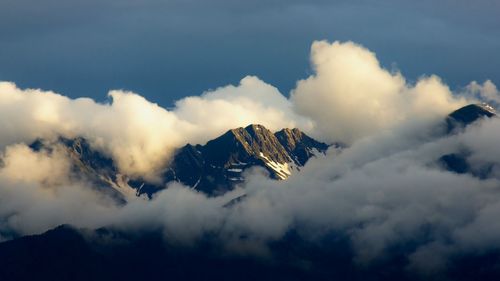 Alpine mountain in the clouds at sunset
