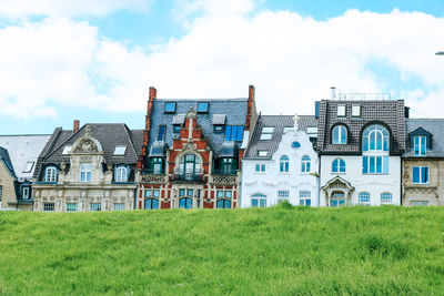 Buildings in lawn against sky