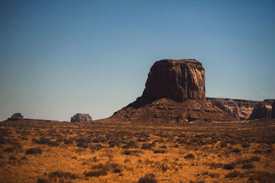 Rock formations in desert against clear blue sky