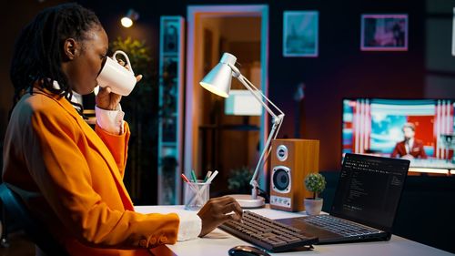 Businesswoman using laptop at table