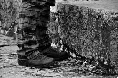 Low section of man standing on ground