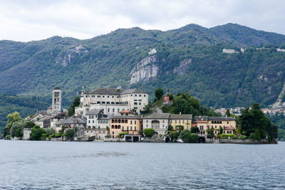 Scenic view of buildings and mountains against sky