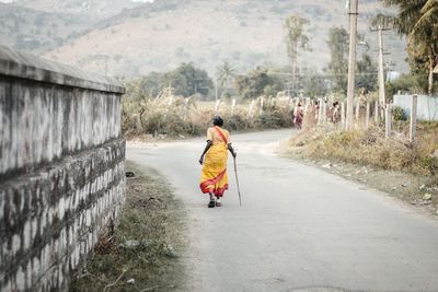 Full length of woman on road