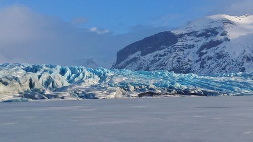 Scenic view of frozen lake against sky