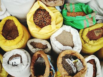 High angle view of grains in sacks for sale at market stall