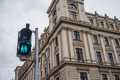 Low angle view of road sign against building