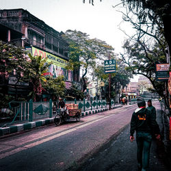 People on city street against sky