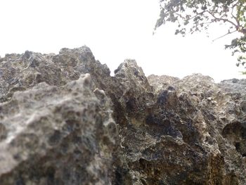Low angle view of rocks against clear sky