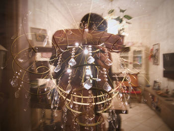 Digital composite image of man holding glass decoration