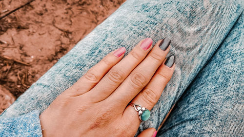 Midsection of woman sitting outdoors