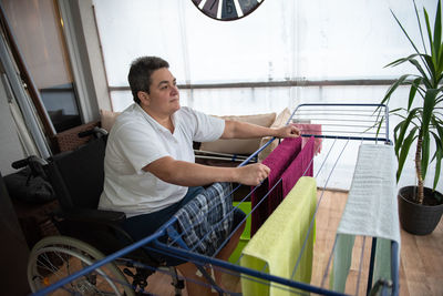 Low angle view of young man sitting in boat