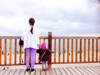 Silhouette of woman standing against cloudy sky