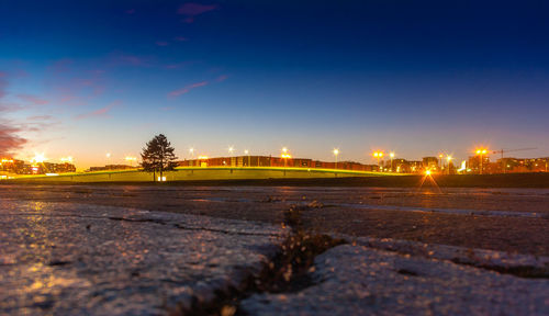 View of illuminated street during winter at night