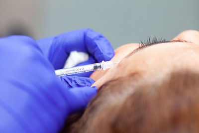 Dermatologist applying botulinum toxin to a middle age female patient. aesthetic medicine.