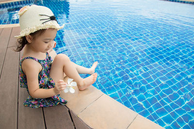 High angle view of woman sitting on swimming pool