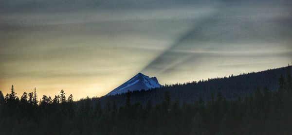 Scenic view of silhouette mountains against sky at sunset