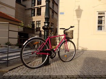 Bicycle on street against buildings in city