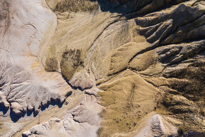 Surrealistic aerial image of abandoned opencast mine. bad land pattern and lake from a drone