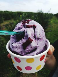 Close-up of hand holding ice cream