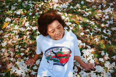 High angle view of woman with autumn leaves