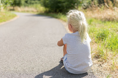 Full length of woman sitting outdoors