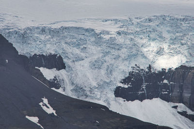 High angle view of snow covered land and sea