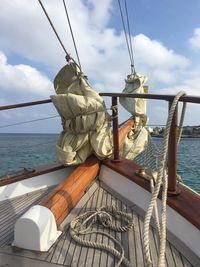 Close-up of ship sailing on sea against sky