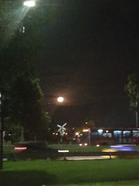 Illuminated city against sky at night