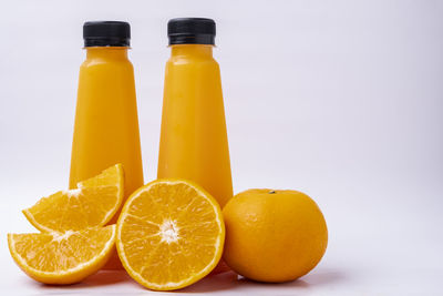 Close-up of orange fruit against white background