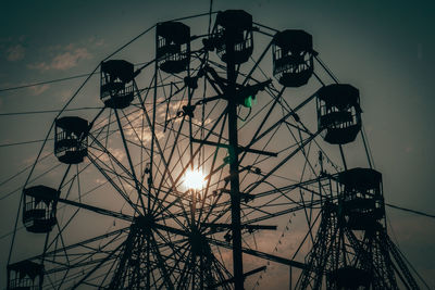 Low angle view of silhouette ferris wheel against sky at sunset