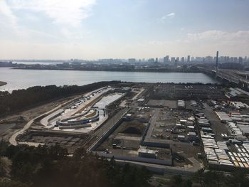 High angle view of highway by river against sky