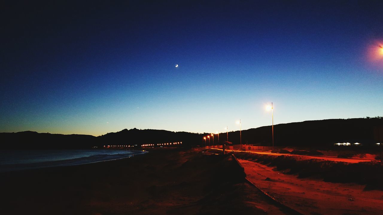 illuminated, night, transportation, road, clear sky, copy space, the way forward, street light, light trail, street, scenics, sky, tranquil scene, car, mountain, long exposure, tranquility, nature, dusk, diminishing perspective