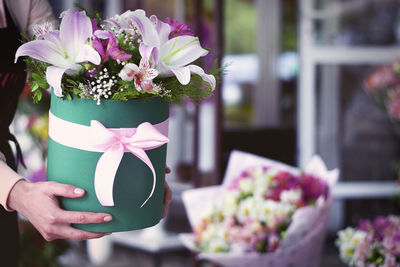 Close-up of hand holding bouquet of pink flower