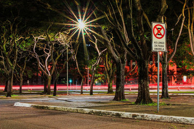 View of road sign at night