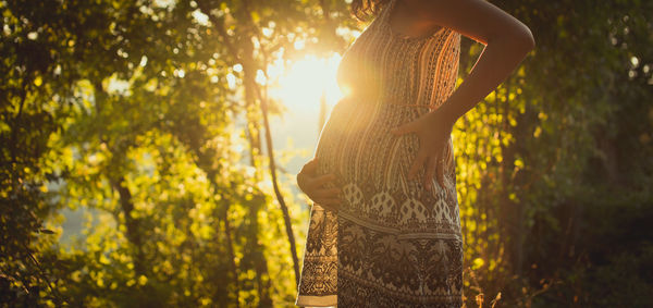 Close-up of pregnant woman holding her belly