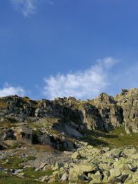 Scenic view of rocky mountains against blue sky