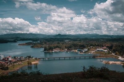 High angle view of lake by city against sky