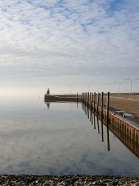 Pier over sea against sky