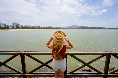 Beautiful young woman with hat looking espirito santo landscape in brazil