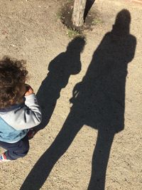 High angle view of people shadow on street