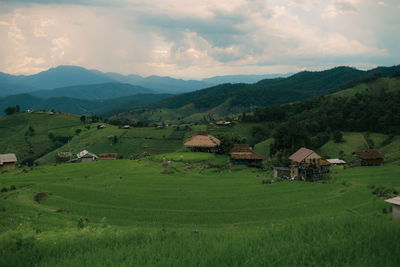 Scenic view of field and mountains against sky