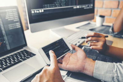 Midsection of man using laptop on table