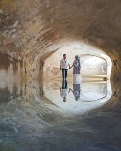 Man and woman standing in tunnel