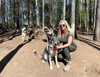 Portrait of woman with dog in forest